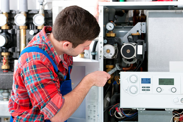 HVAC technician inspecting an indoor heating system in Avondale, AZ